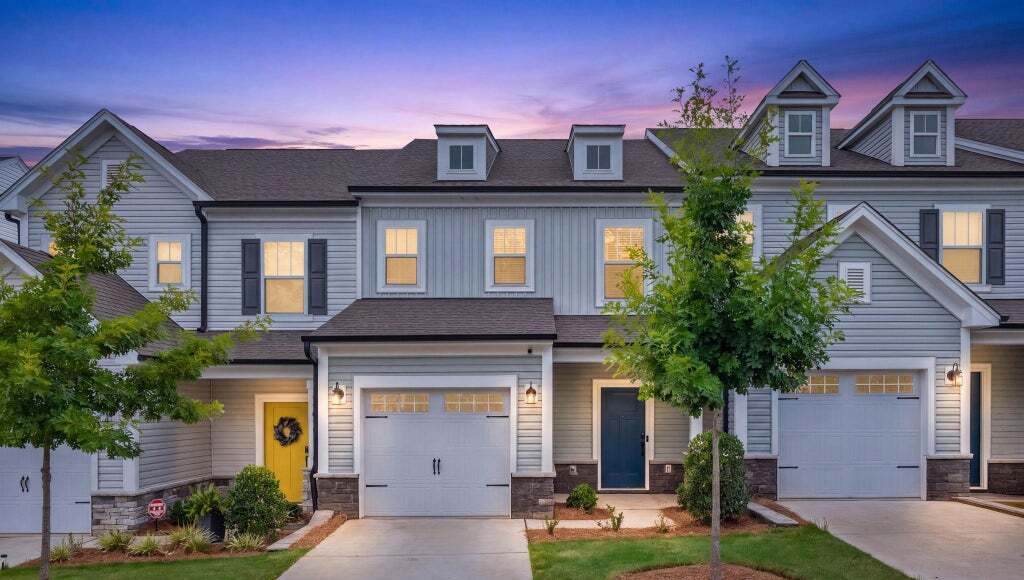 Twilight exterior view of 11012 Pagebrook Lane townhome with yellow front door